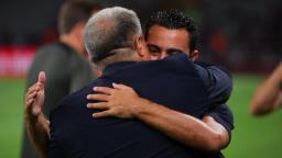 Xavi Hernandez hugs President Joan Laporta