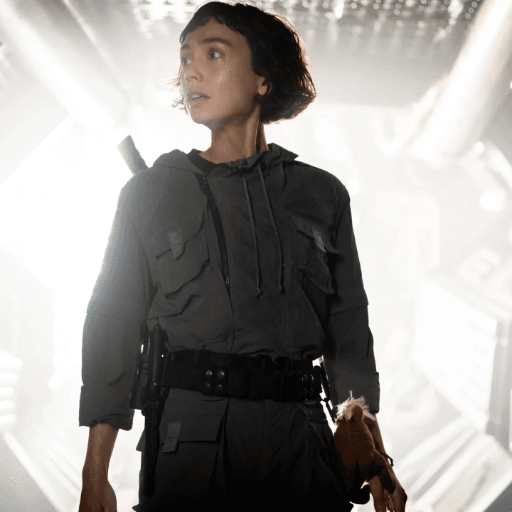 A character looking to her right while light emanates from behind her in Alien: Earth