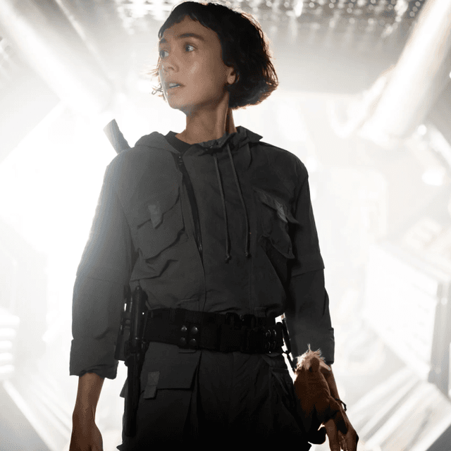 A character looking to her right while light emanates from behind her in Alien: Earth