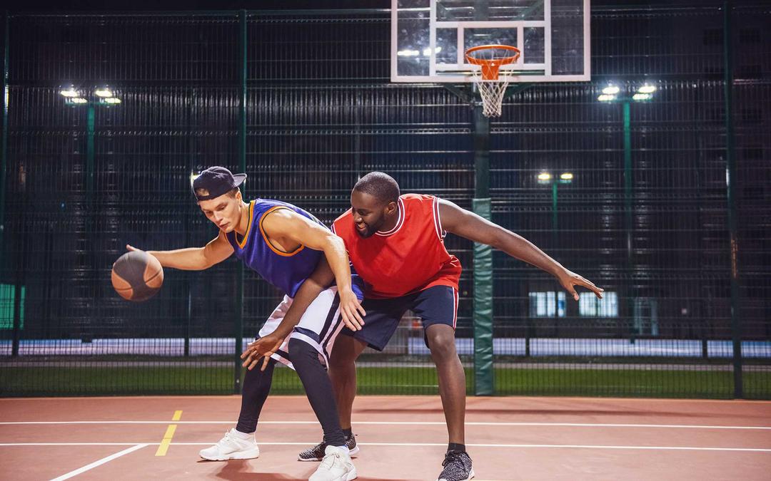 Two people playing basketball