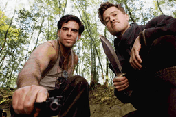 Brad Pitt with a knife in hand and crouching down in Inglourious Basterds