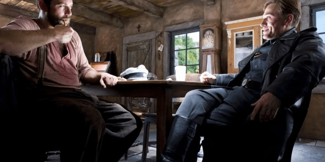 Hans Landa and La Padite sitting and smoking in the opening scene of Inglorious Basterds.