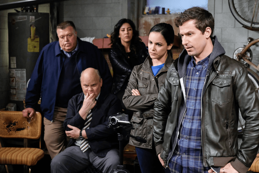 The cast of B99 standing