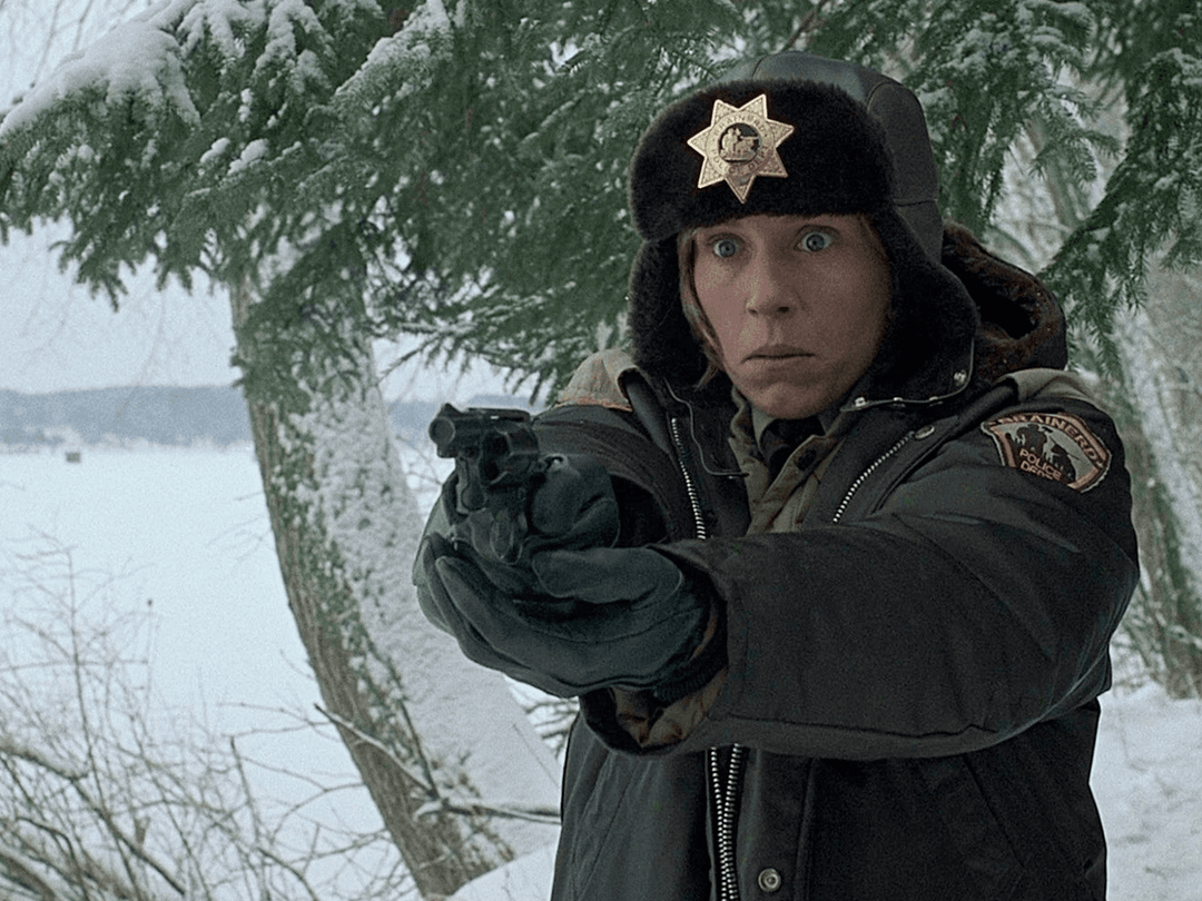 A woman holding out a gun and being scared