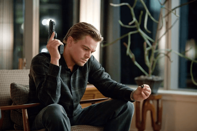 Leonardo DiCaprio holding a gun in Inception