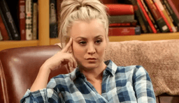 Penny with one hand on her head as if thinking in The Big Bang Theory.
