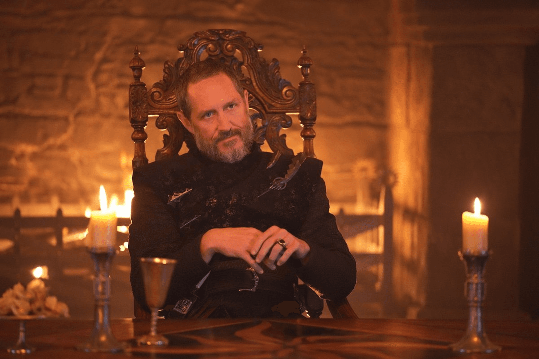 Baelor Targaryen sitting with his hands in his lap in A Knight of the Seven Kingdoms